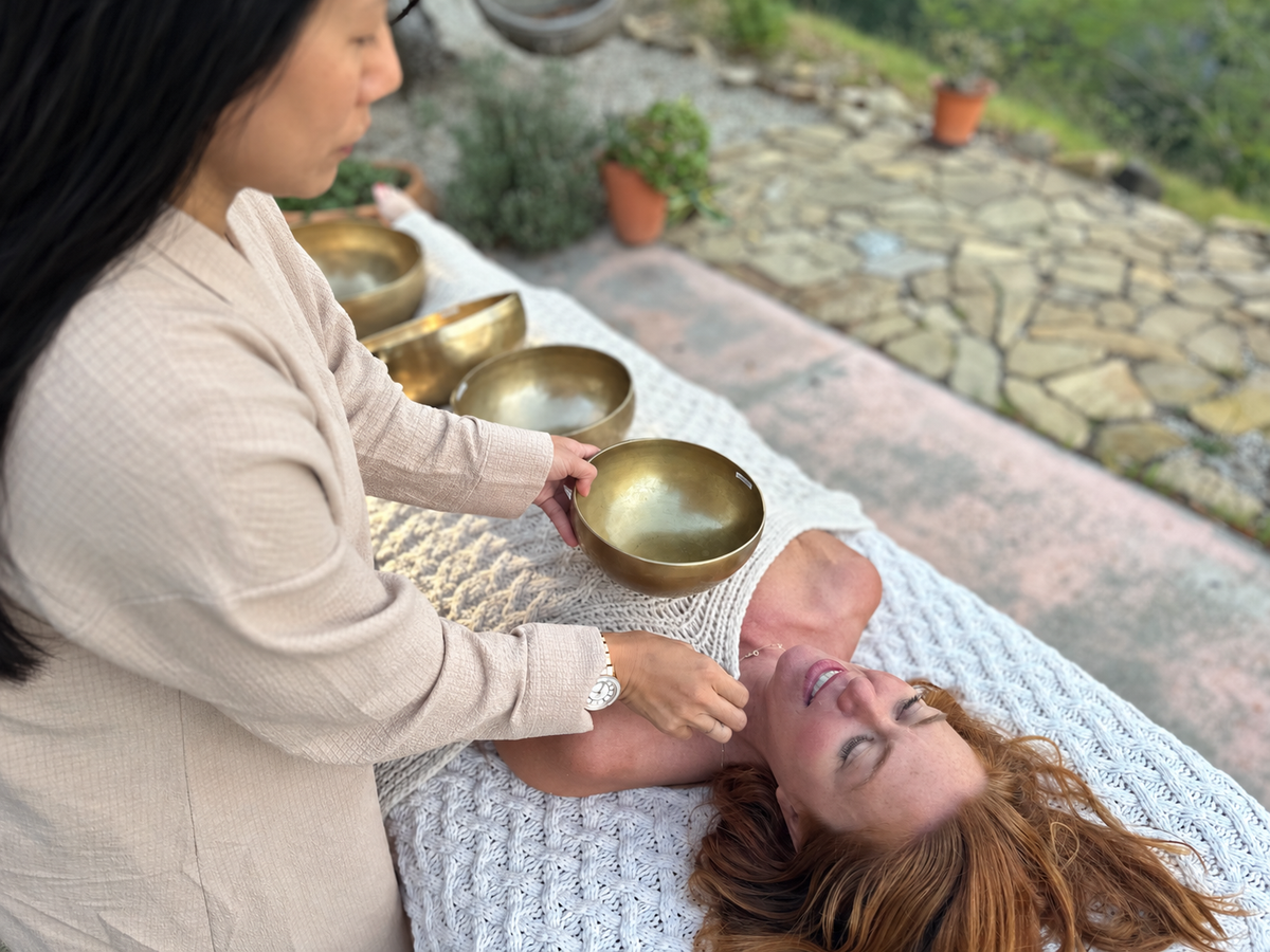 Yama demonstrating on-body singing bowl therapy